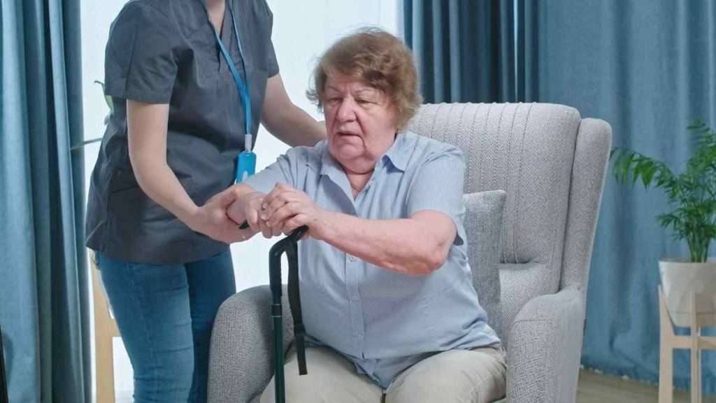 Caregiver assisting a senior with a cane.