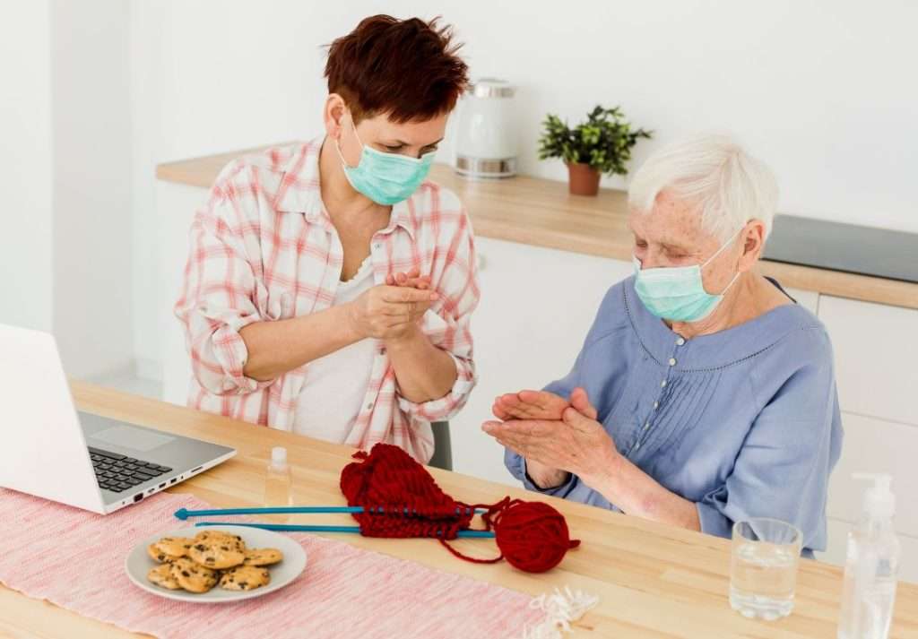 Professional non-medical home care caregiver supporting an elderly woman at home