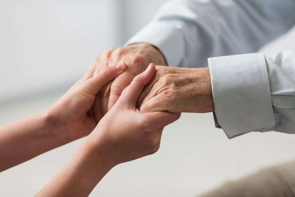 Person with hand tremor, a common symptom of Parkinson's disease.
